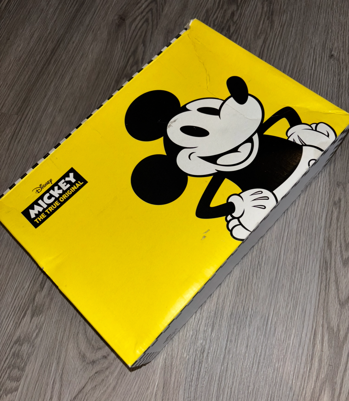 Yellow box with a cartoon character on a wooden surface