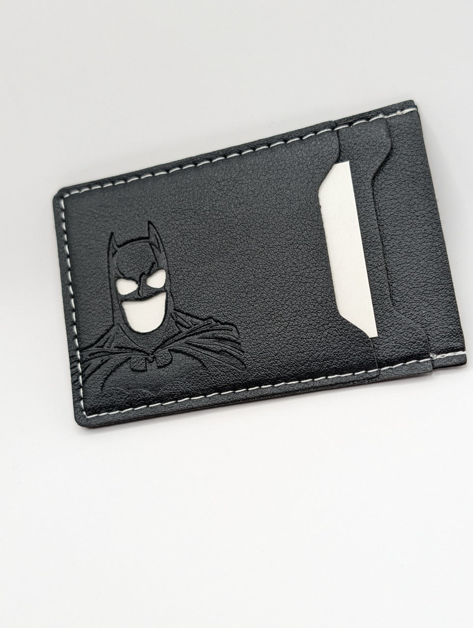 Black leather cardholder with Batman logo on a white background