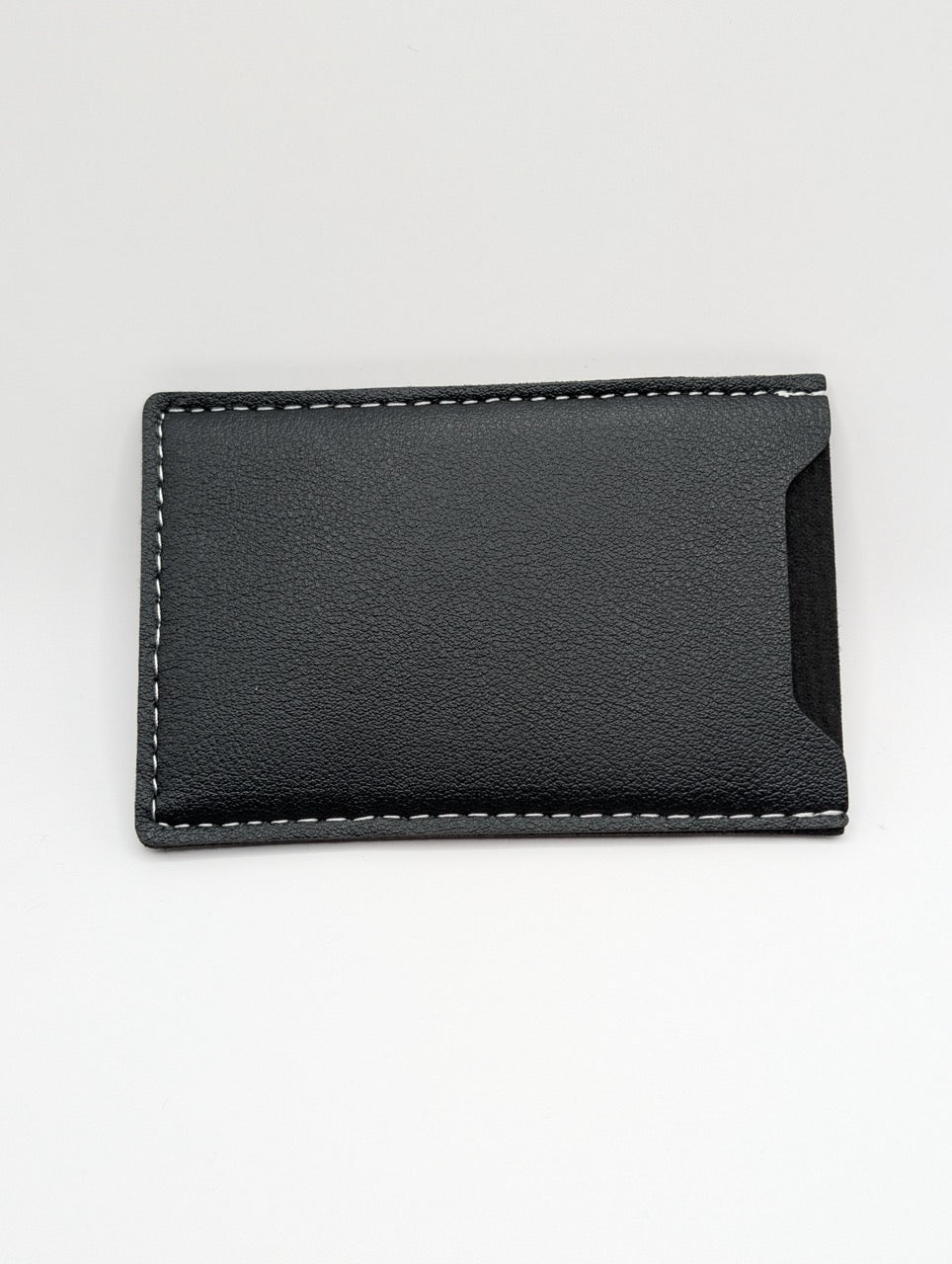 Black leather wallet on a light gray background